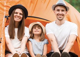 Parents and child camping