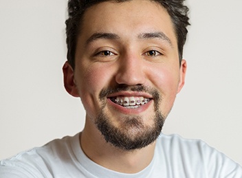 a smiling man with braces