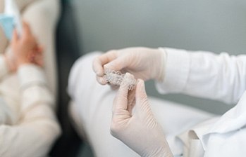 Dentist holding Spark aligner at appointment