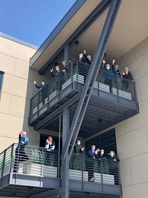 Team members on exterior stairs of office