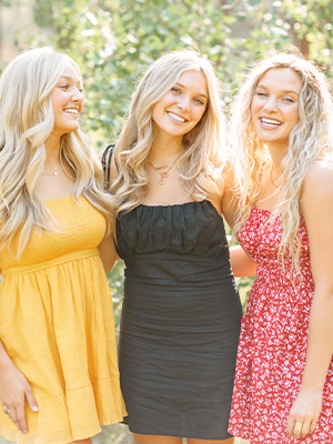 Three orthodontic patients smiling