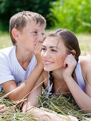 Child with Forsus fatigue resistant orthodontic device with mother in the park