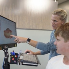 Orthodontist taking digital scans of a patient's teeth