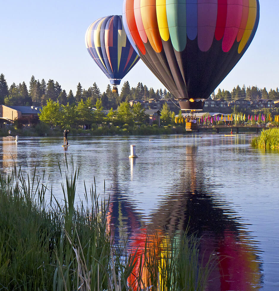 Hot air balloons over a river