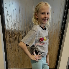 Smiling young girl riding a horse