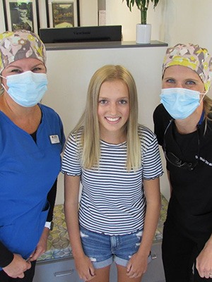 Team members smiling with patient