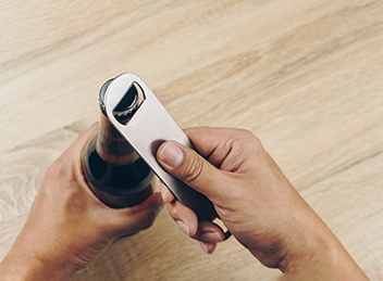 Patient using bottle cap opener