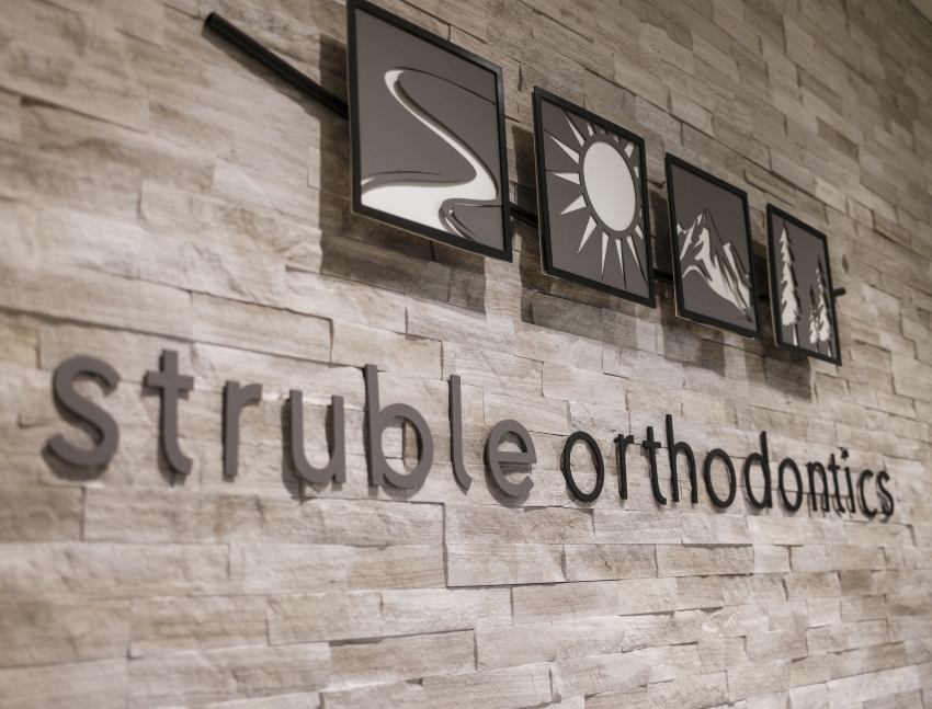 Date of an orthodontic appointment marked on a calendar with a pin