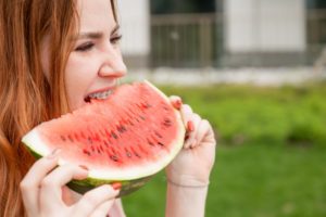 girl with braces eating a watermelon 