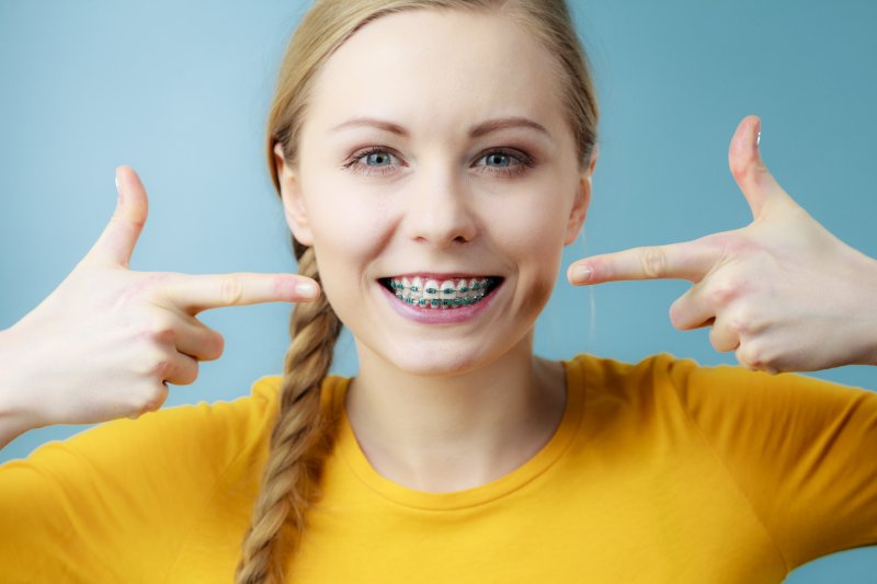 Young woman pointing to her braces